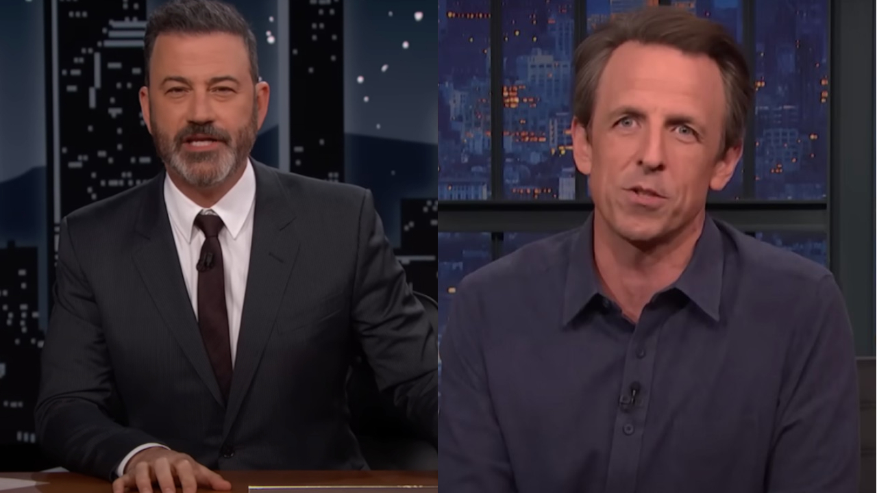 Jimmy Kimmel sits at his desk for Jimmy Kimmel Live, pictured next to Seth Meyers doing the same for Late Night with Seth Meyers.